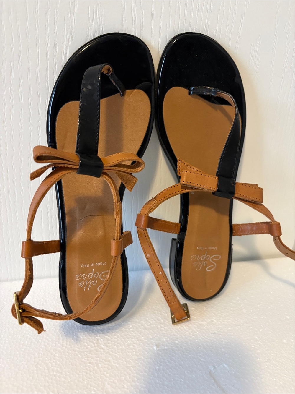 Casual Black and Tan Bow Toe-Post Sandals by Bella Sofia